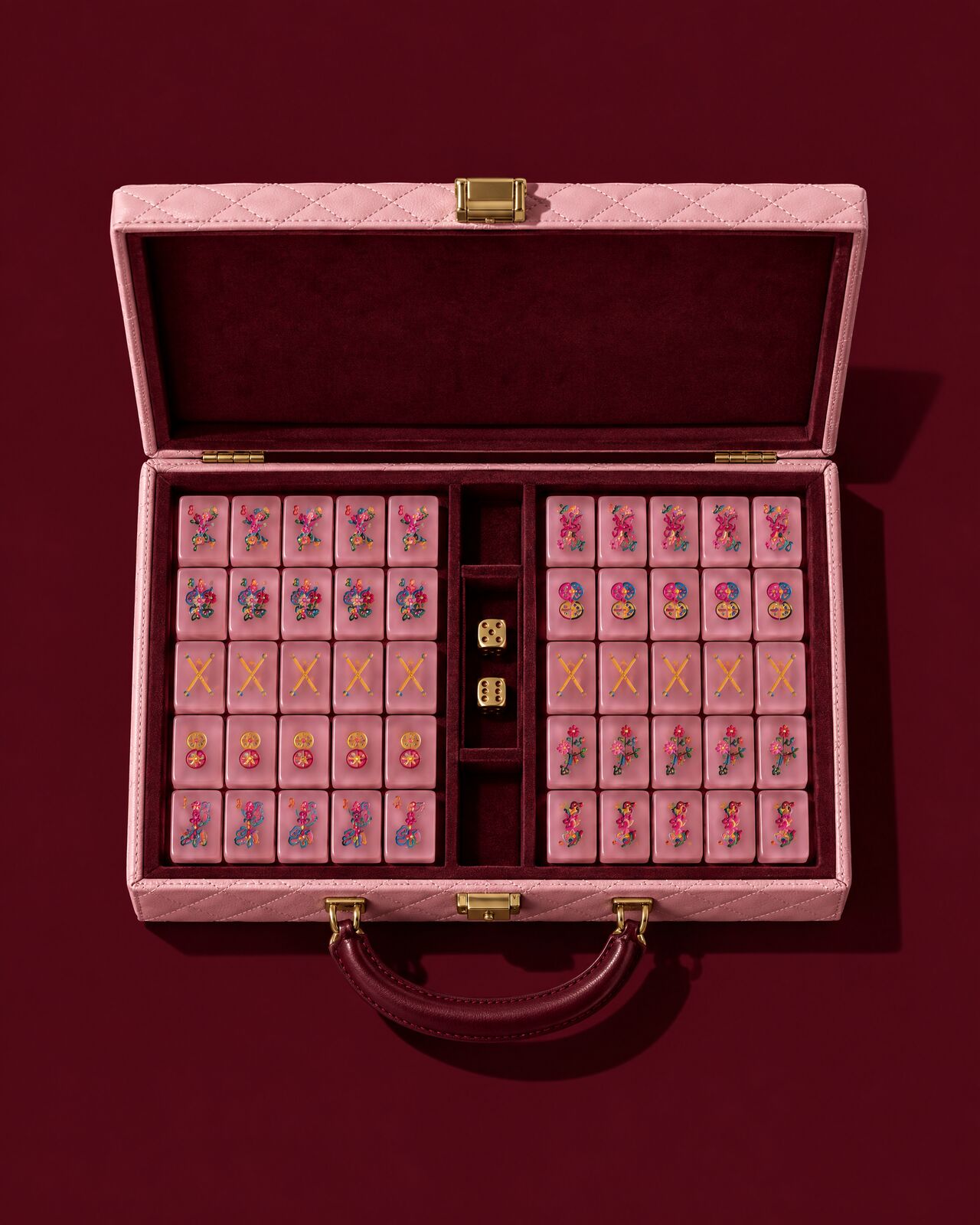 The quilted blush case open flat on oxblood, full of tiles