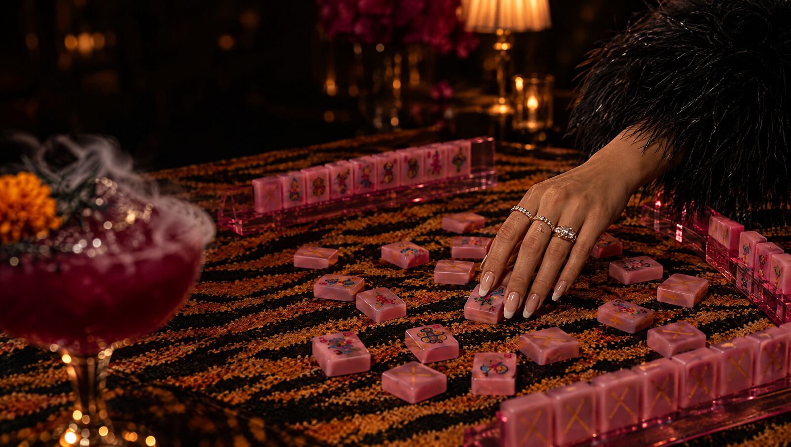 A tiger-stripe table mid-game by lamplight