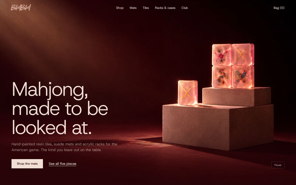 Plinth homepage on desktop: glowing pink tiles on plaster plinths under a spotlight
